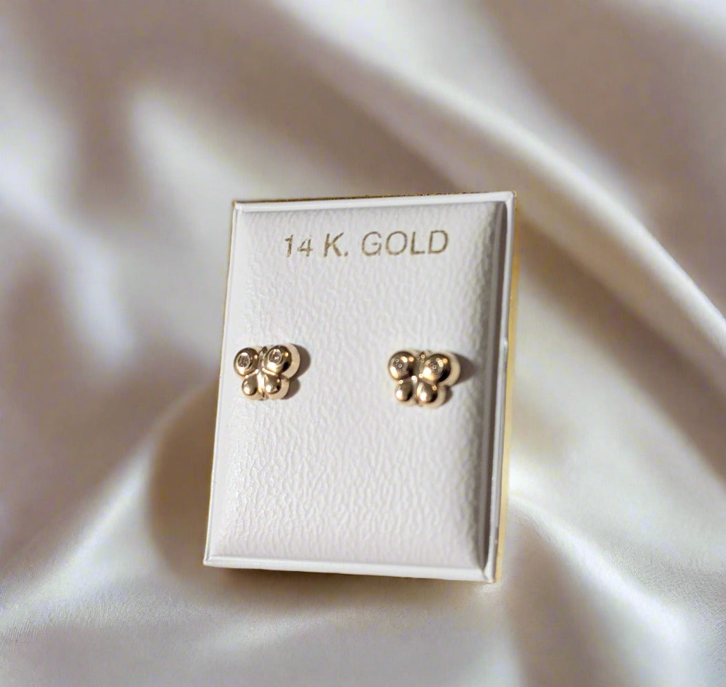 Pair of gold earrings on a white card labeled '14 K. Gold' against a light gray background