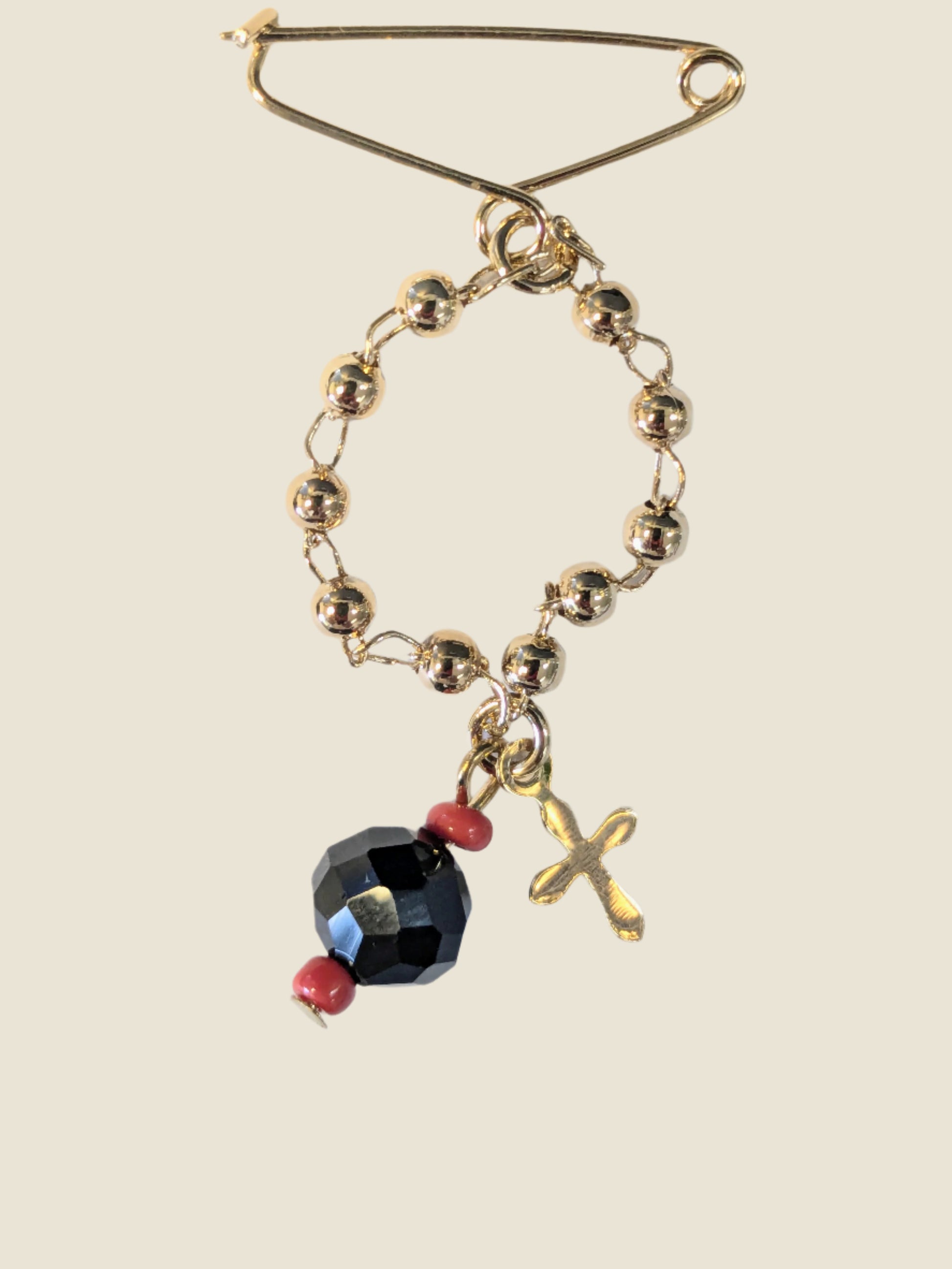 Gold Filed Azabache Pin with charm coral beads and small cross.