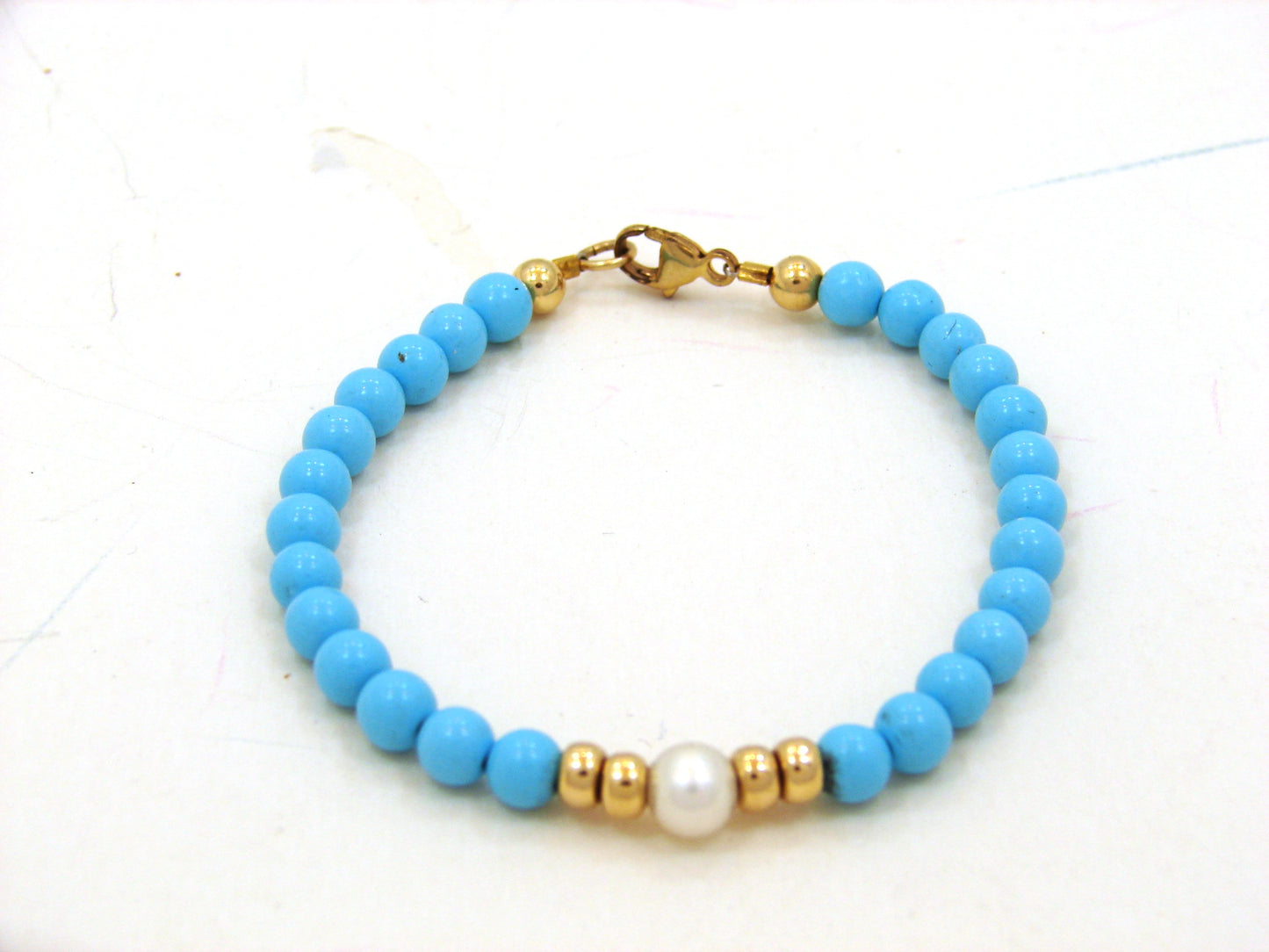 14 KT Princess bracelet 2 roundels on each side of a center pearl with turqoise