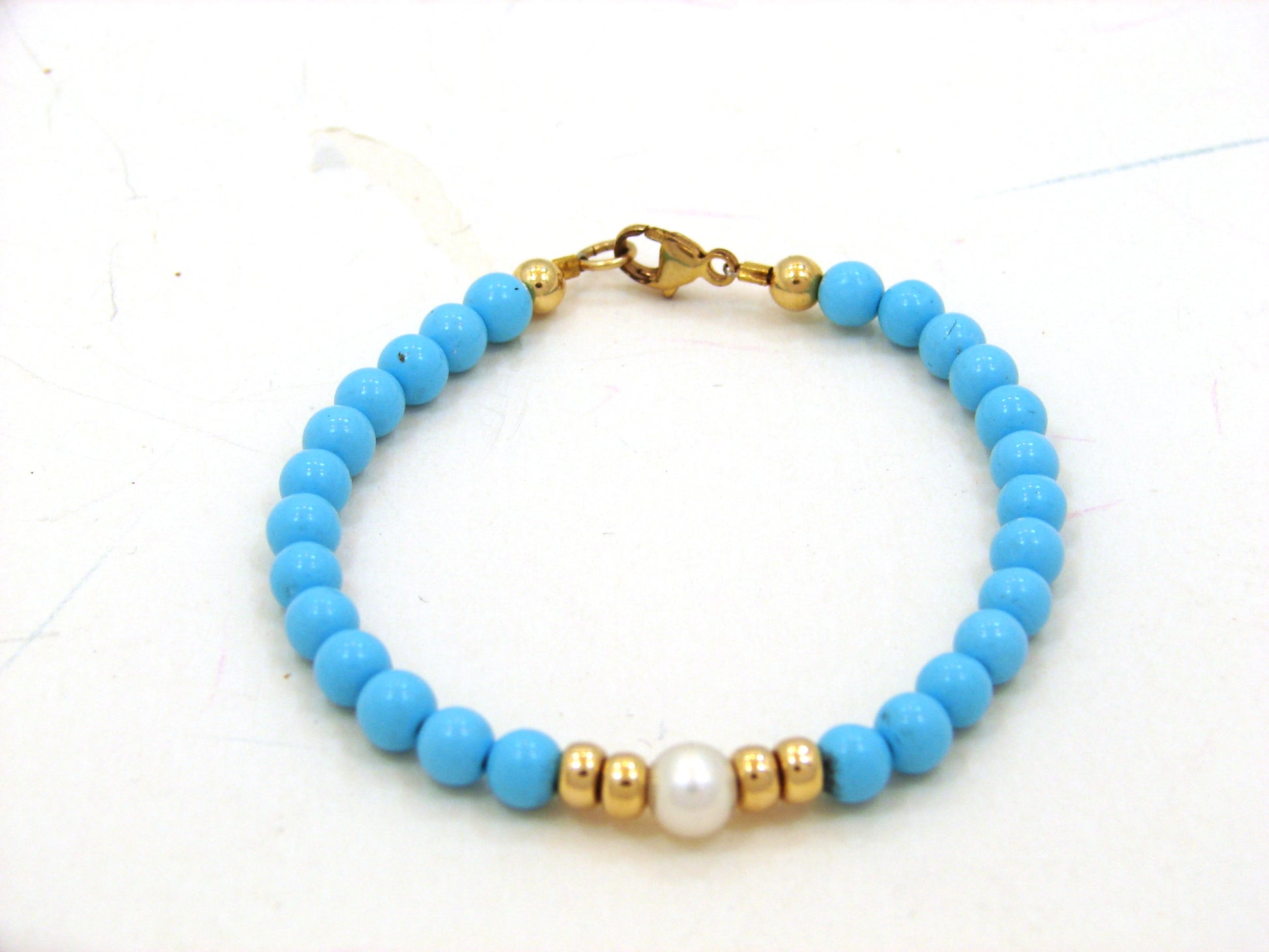 14 KT Princess bracelet 2 roundels  on each side of a center pearl with turqoise