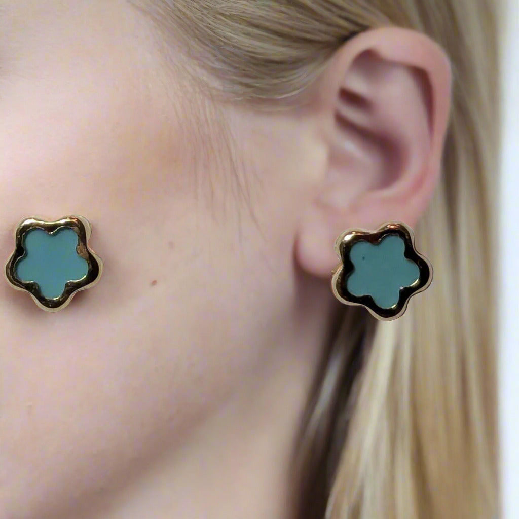 Blue flower-shaped earrings on a white card with '14 K. Gold' text.