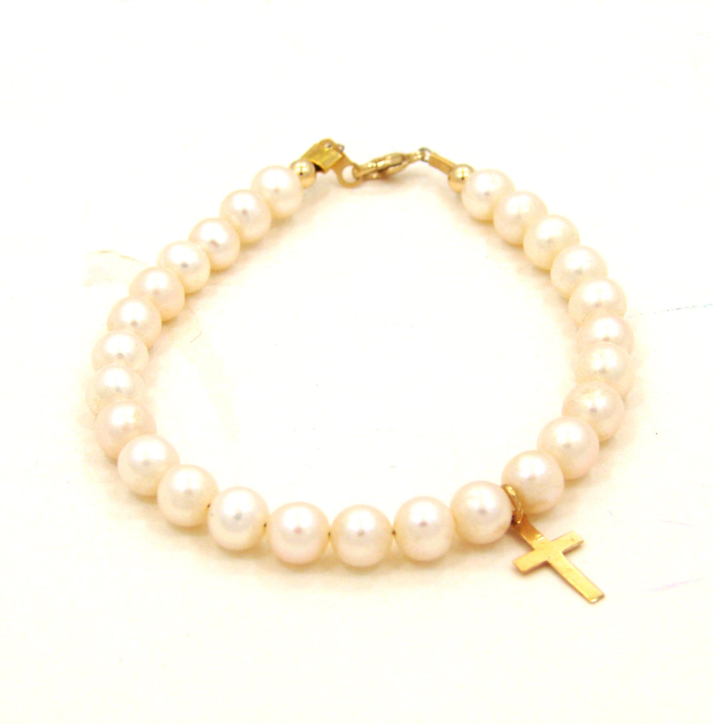 14 KT Mindy Harris Pearl Bracelet with cross lobster clasp and polished beads. 