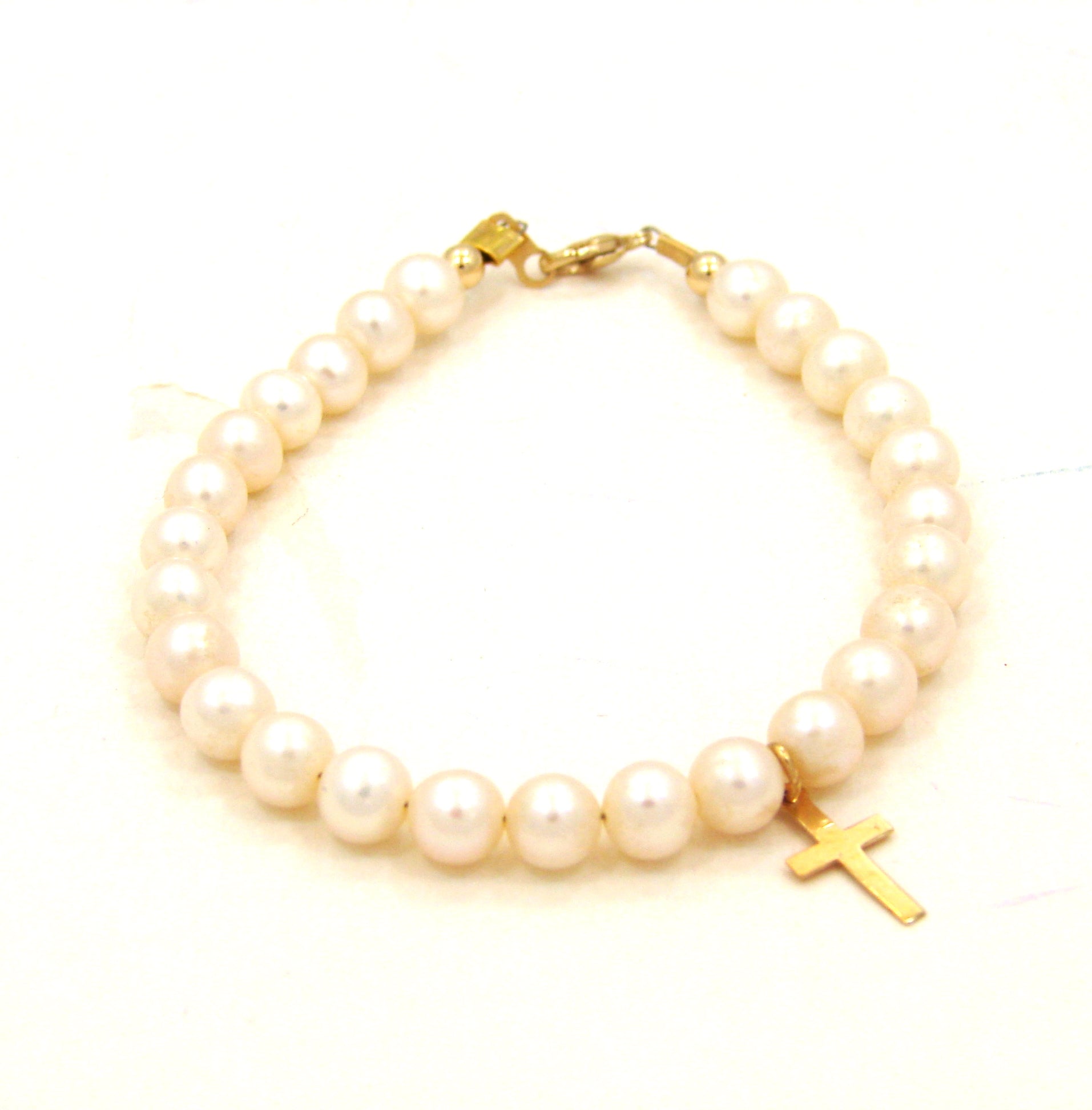 14 KT Mindy Harris Pearl Bracelet with cross lobster clasp and polished beads. 